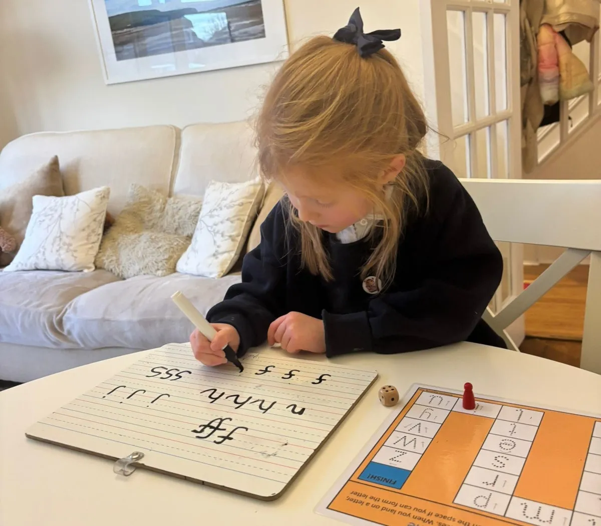 Two girls writing on carpet